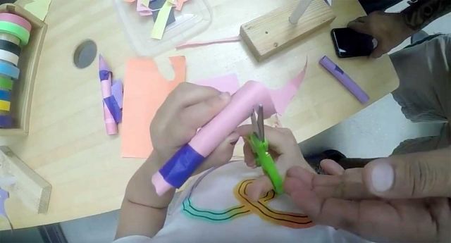 Child and Parent build rocket.